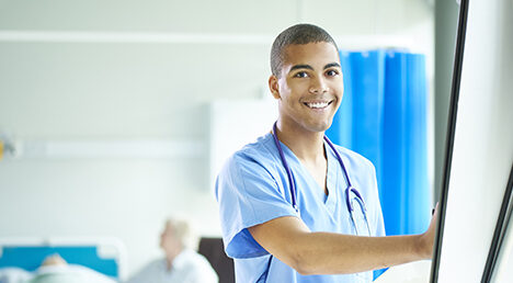 proud young male nurse on the ward