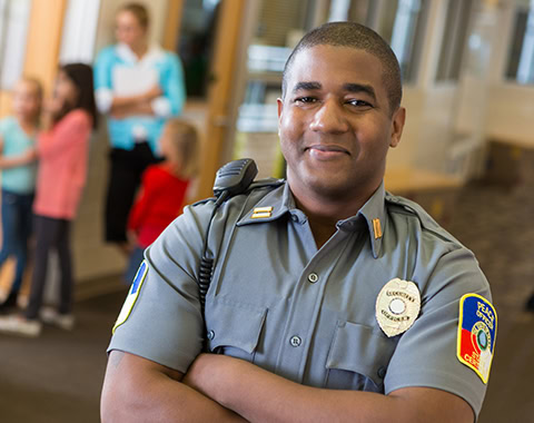Friendly school security guard working on elementary school campus