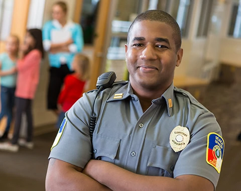 Friendly school security guard working on elementary school campus