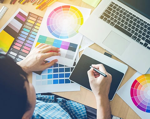 Graphic designer drawing on graphics tablet at workplace