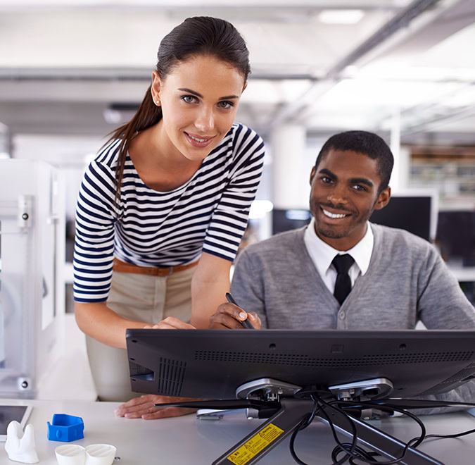 Portrait of a two colleagues working on a large touchscreen monitor in an office