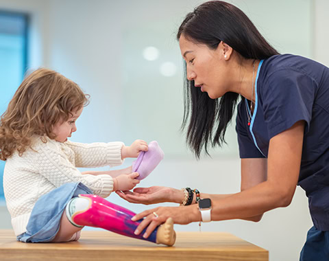 Little girl with prosthetic leg at medical appointment