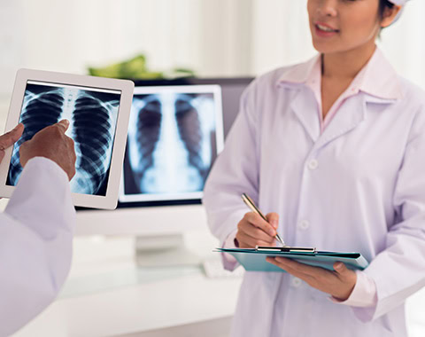 Doctor and nurse discussing the x-ray of the patient