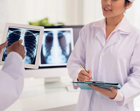 Doctor and nurse discussing the x-ray of the patient