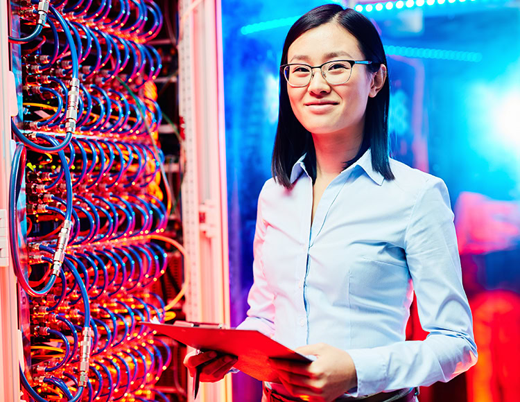 Young researcher looking at camera in data center
