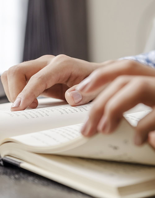Closeup of human hand reading