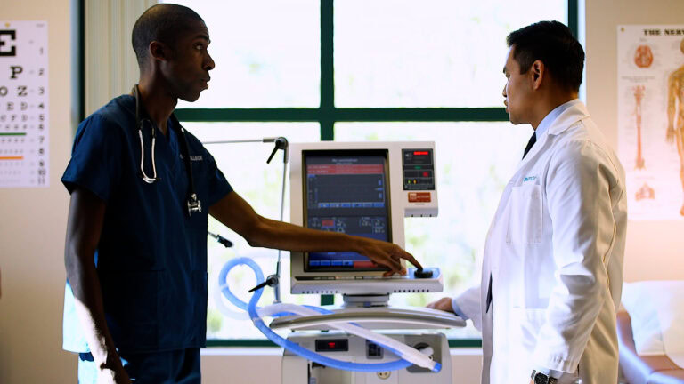 Medical professionals discussing patient data in a clinical setting at Platt College.
