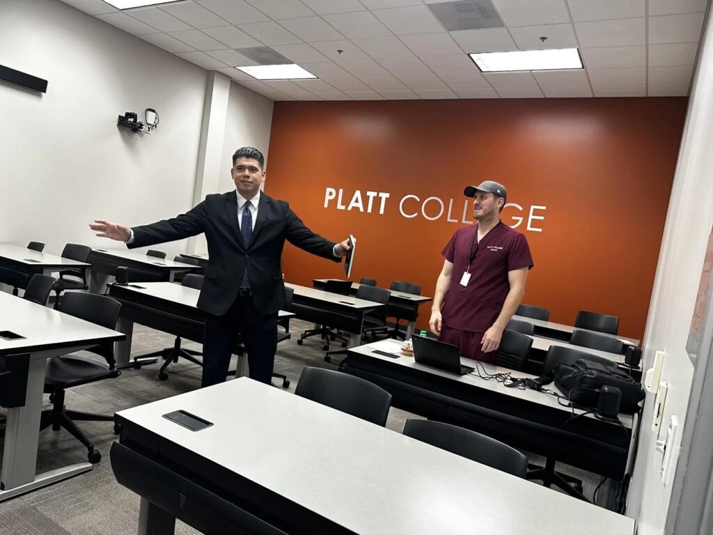 James De Loera meets with Platt College Riverside leadership in a classroom.