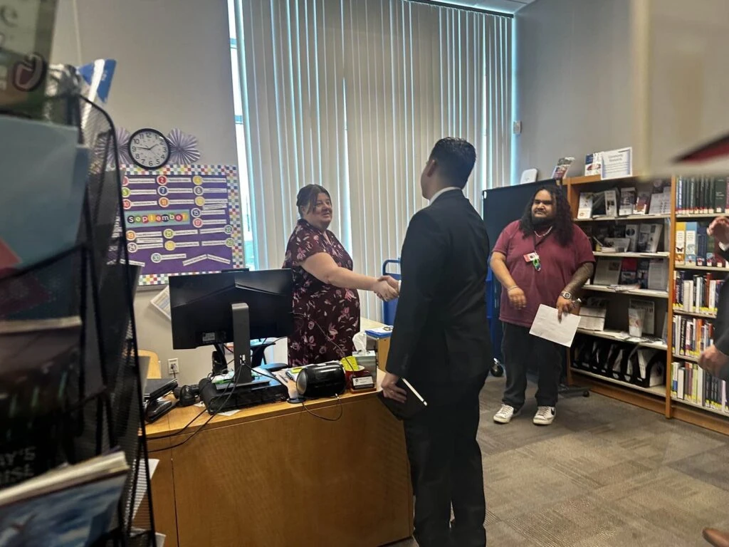 James De Loera tours the Platt College Riverside library with staff.